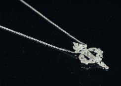Diamond set fancy pendant necklace depicting a flaming torch surrounded by a floral wreath,