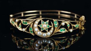 An emerald and pearl star and crescent bangle, openwork design with a central pearl and emerald star
