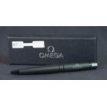 Omega matte black ballpoint pen, in cardboard Omega box with lid.