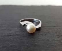 Solitaire pearl ring mounted in white metal stamped 18k, finger size N 1/2, gross weight