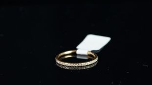 A diamond full eternity ring, round brilliant cut diamonds, claw set in 18ct rose gold, finger