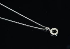 Diamond circular pendant with chain, mounted in white metal stamped 750, set with twelve round