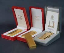 Mixed lot of four lighters including 1x Cartier lighter with serial 1B05445, 1x Must de Cartier