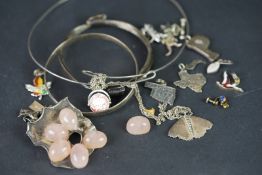 A selection of silver and costume jewellery, including brooches, pendants and charms