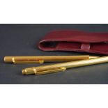 Must de Cartier gold cased ballpoint pen and pencil set, serial numbers H449 and 298917, in fitted