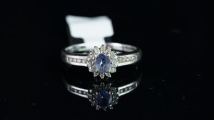 A tanzanite and diamond cluster ring in 9ct white gold , gross weight approximately 2.99 grams,