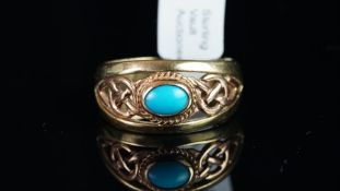 A turquoise band ring, set with an oval cut turquoise at the centre, within a Celtic knot,