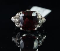 Garnet and diamond ring, mounted in unmarked white metal partially stamped 75, central cushion