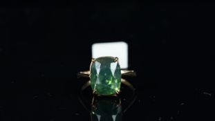 A single stone green zircon ring, cushion shaped green zircon weighing an estimated 11.80ct, mounted