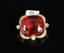 An early 20th century tourmaline and diamond brooch, central cushion cut red tourmaline measuring