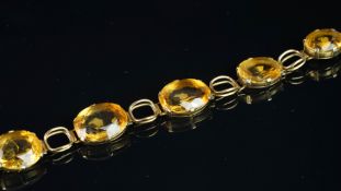 Citrine bracelet, mounted in yellow metal, set with six oval citrines, with tongue and box clasp,
