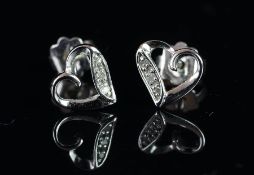 Pair of heart shaped diamond set stud earrings, mounted in unmarked white metal, butterfly