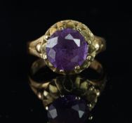 Single stone ring, set with a synthetic colour changing stone, mounted in yellow metal stamped