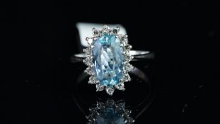 Blue topaz and diamond oval cluster ring, mounted in unmarked white metal tested as 9ct gold,