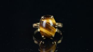 Single stone Tiger's Eye ring, oval cabochon Tiger's Eye, mounted in hallmarked 9ct yellow gold,