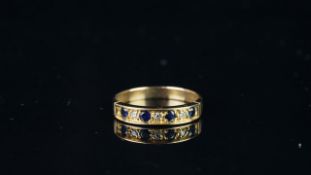 Seven stone blue and white stone half eternity ring, mounted in hallmarked 9ct yellow gold, finger