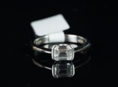 Single stone diamond ring, emerald cut diamond weighing an estimated 0.71ct, estimated colour F,