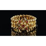 Victorian ruby and diamond expanding bracelet, central floral motif set with rubies and old cut