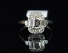 Diamond cluster ring, central emerald cut diamond, with two baguette cut diamonds each side, and