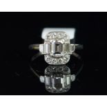 Diamond cluster ring, central emerald cut diamond, with two baguette cut diamonds each side, and