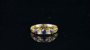 Sapphire and diamond carved half hoop ring, mounted in yellow metal stamped '18', set with three