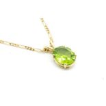 A single stone peridot pendant, oval cut peridot measuring 11.5 x 9.4mm, mounted in 9ct yellow