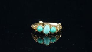 Turquoise three stone carved ring, central oval cut turquoise a round cut to each side, carved