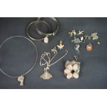 A selection of silver and costume jewellery, including brooches, pendants and charms