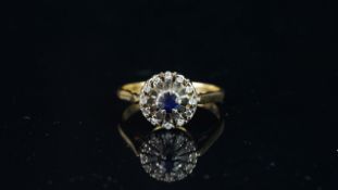 Sapphire and diamond round cluster ring, mounted in hallmarked 18ct yellow & white gold, finger size