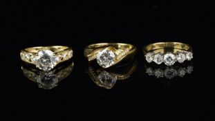 Three cubic zirconia rings, one set in 9ct yellow gold and two set in 14ct yellow gold, total