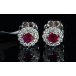 NEW OLD STOCK, UNWORN RETIRED STOCK - A pair of ruby and diamond stud earrings, round cut rubies