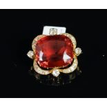 An early 20th century tourmaline and diamond brooch, central cushion cut red tourmaline measuring