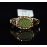 Antique mourning ring, black enamel foliate design shoulders, mounted in unmarked yellow metal,