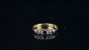 Five stone blue and white stone carved half hoop ring, mounted in hallmarked 9ct yellow gold, finger