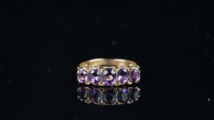 Five stone amethyst carved half hoop style ring, mounted in hallmarked 9ct yellow gold, finger