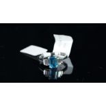 NEW OLD STOCK, UNWORN RETIRED STOCK - A blue topaz and diamond ring, central emerald cut blue