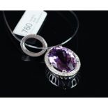 NEW OLD STOCK, UNWORN RETIRED STOCK - An amethyst and diamond pendant, central oval cut amethyst