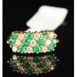 An emerald and diamond ring, designed as alternating diagonal rows, mounted in 18ct yellow gold,