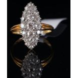 A Victorian diamond ring, old cut diamonds set in a navette shaped panel, on a tapering yellow metal