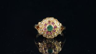 Green, red and white stone circular cluster ring, mounted in hallmarked 9ct yellow gold, finger size