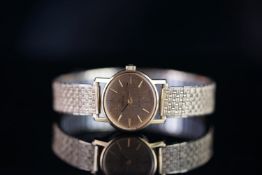 LADIES OMEGA DE VILLE, oval champagne dial, baton hour markers, 24mm gold plated case, later