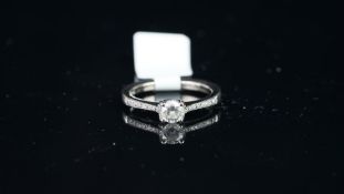 Solitaire brilliant cut diamond ring, with diamond set shoulders, mounted in hallmarked 18ct white