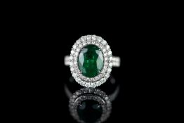 Emerald and diamond ring, 1 oval cut emerald estimated 3.70ct, 4 claw set, surrounded by 72 round