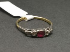 Three stone ruby and diamond ring, mounted in yellow and white metal stamped '18CT PLAT', central