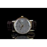 GENTLEMEN'S GARRARD QUARTZ WRISTWATCH, circular silver dial with yellow gold hour markers and hands,