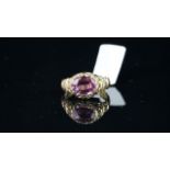 Pink Sapphire ring, approximately 8.8x7mm oval cut pink sapphire, set within an engraved scroll