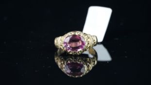 Pink Sapphire ring, approximately 8.8x7mm oval cut pink sapphire, set within an engraved scroll