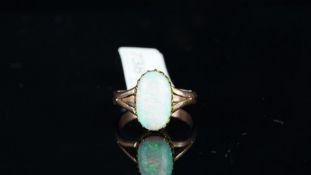 Opal dress ring, oval cabochon of opal measuring 13.85 x 8.02 x 3.30mm, claw set in rose gold, split