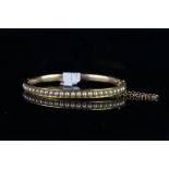 Edwardian pearl set bangle, 5mm wide rose gold hinged bangle, top half set with approximately 27 ,