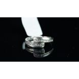 Diamond crossover ring, mounted in unmarked white metal, stamped DIA inside shank, finger size L,